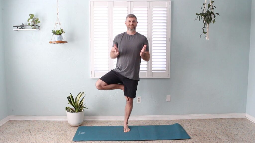 Phil Vestal practicing Tree Posture in a Christian yoga class, symbolizing being rooted in Christ and grounded through faith.