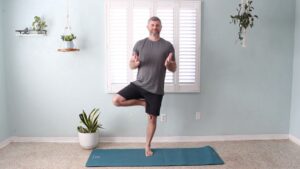 Phil Vestal practicing Tree Posture in a Christian yoga class, symbolizing being rooted in Christ and grounded through faith.
