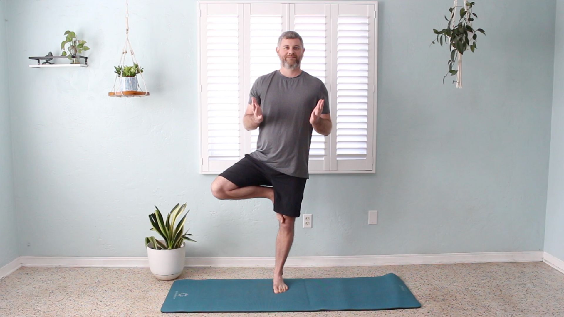 Phil Vestal practicing Tree Posture in a Christian yoga class, symbolizing being rooted in Christ and grounded through faith.